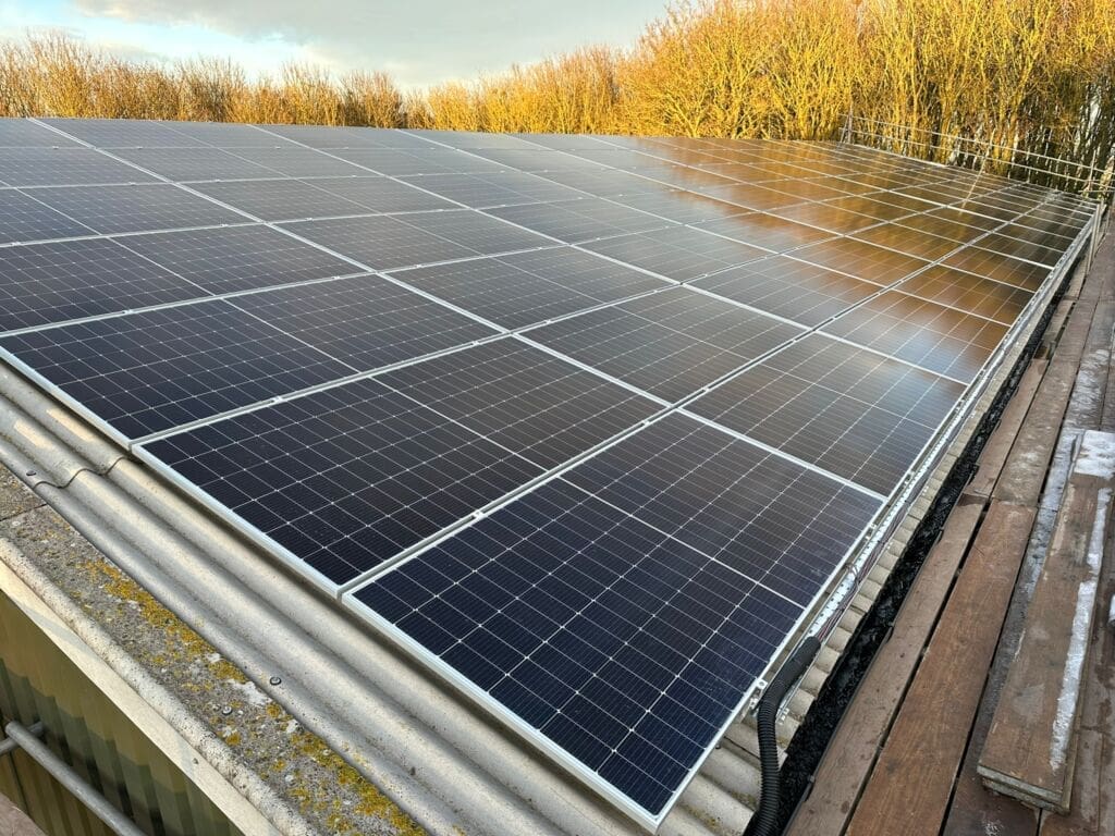 Black solar panels on a warehouse roof