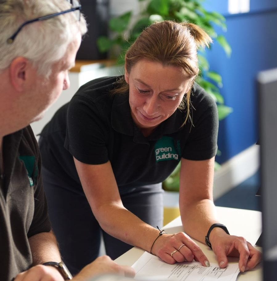 Two Green Building Renewables employees looking at a document