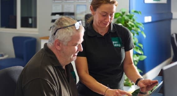 Two Green Building Renewables installers looking at an iPad. 