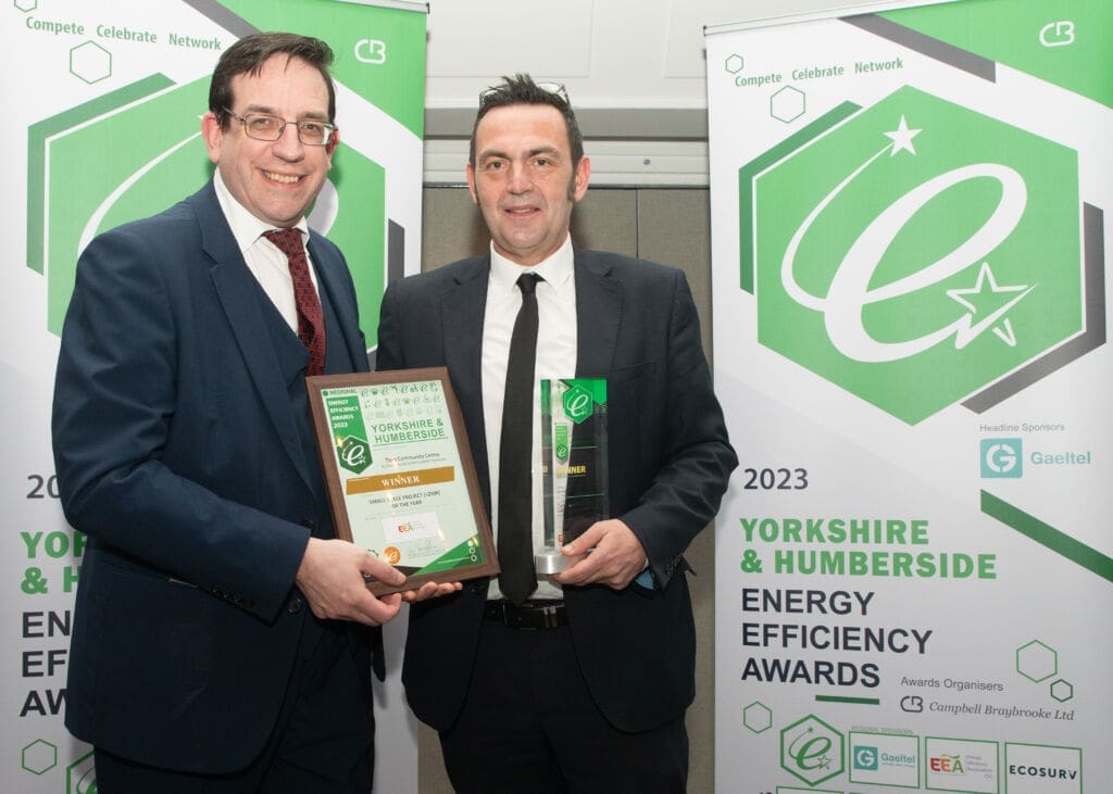 Green Building Renewables Commercial Manager Chris Garvey collects the award at the Yorkshire Energy Efficiency Awards for Tang Hall Community Centre.