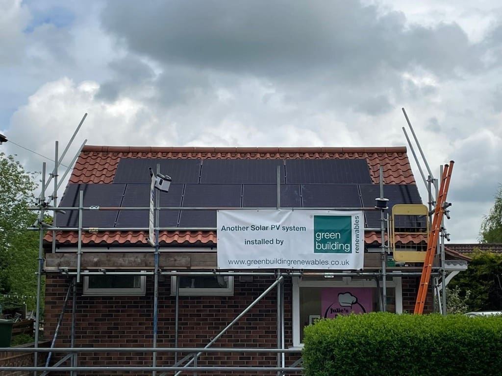 A house with black solar panels on the roof