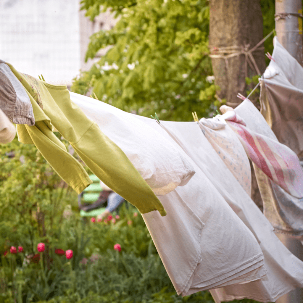 An image of a washing line with clothes hung outside as part of an expert tip to save money on energy bills. 